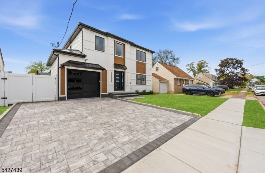 This thoughtfully designed residence rests on a prime location, blending timeless comfort with contemporary convenience. The first floor invites you into a welcoming living room, flows into a generous dining room, and opens to a modern kitchen adjacent to a versatile family room anchored by a custom fireplace-the heart of home life. A full bath on this level adds practical versatility for guests or daily living, while large windows invite abundant natural light and a sense of airiness. Upstairs, three spacious bedrooms offer retreat and restful privacy, complemented by a full bath and a convenient laundry room. The centerpiece is a lavish master suite featuring two walk-in closets and a full bath with a freestanding bathtub, a refreshing separate shower, and a double sink vanity designed for everyday luxury. The upper level provides comfort with thoughtful layout and ample storage.The finished basement expands living space with a full bathroom, ideal for entertainment, work from home, or recreation. Modern amenities include built-in cameras for security and built-in speakers for seamless ambiance throughout the home. This property combines practical modern systems with refined finishes, creating a welcoming, move-in-ready home. A rare opportunity to own new construction that feels timeless, bright, and endlessly adaptable.