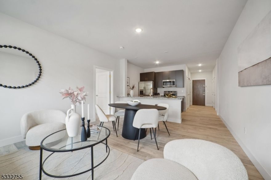 Welcome to 227 North Walnut, a newly constructed 5-story residential building in East Orange, NJ, offering modern living with a touch of classic style. This spacious 2-bedroom, 2-bathroom unit is designed with both comfort and style in mind. Large windows fill the space with natural light, enhancing the apartment's inviting atmosphere. Both bedrooms are generously sized, with the primary bedroom offering an ensuite bathroom and both equipped with large closets for ample storage. Key features include stainless steel appliances and granite countertops ideal for culinary enthusiasts, and an in-unit washer and dryer for added convenience. Residents at 227 North Walnut enjoy access to premium amenities, including a fully equipped fitness center, and a welcoming community room. Safety is a priority with a 24/7 surveillance system and a secure package room. Located just 5 minutes from BrickChurch Station, this unit offers a quick 30-minute commute to NYC. Steps from Sussex Plaza, you'll have dining, shopping, and essentials nearby. The area is also close to parks and green spaces, ideal for outdoor activities, and has easy access to I-280 and the Garden State Parkway. Photos are of similar unit. Parking available for additional cost.