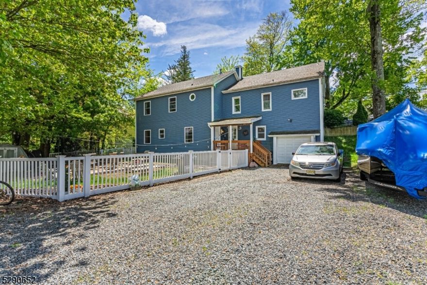 LAKE-LIVING IN LUXURIOUSLY LARGE HOME! Presenting 16 N Shore Road, a 7 Bedroom (or 5 Bedroom with 2 "Bonus  rooms!), 4 Bath Colonial, nestled one block from Indian Lake with spectacular views of the water, and every lake amenity at your disposal! Original part of the house, built in 1920, boasts a bright open Foyer, a charming Dining Room, a farmhouse-feel Kitchen with stainless steel appliances, natural wood countertops, and crisp white cabinetry, 2 sunlit Bedrooms, both with plenty of light and ample closets, and a delightful full Bath with rustic, floating bathtub that will lure you right in when you crave time to unwind. Continue into the 2009 expansion and discover a sizable, yet cozy Living Room with sweet stone fireplace, built in bar area, 2 additional Bedrooms or potential Home Office, Lower Level that was part of the expansion features an enchanting Primary Bedroom with a walk-in-closet as well as En-Suite Bath with spa-like jacuzzi tub and glass door shower. 2 additional Bedrooms, a Family Room, Full Hall Bath, Storage Area and Garage entry. Head out to the fully fenced backyard for all outdoor activities. Indian Lake is one of Denville's most sought after lake communities with private beaches, so many activities, and events year round. Downtown Denville is less than a mile away, packed with shopping, dining, NYC train, and more! 16 N Shore is truly your DREAM HOUSE ON-DECK!  Driveway and additional parking available in the rear of the house on Riekens Tr.