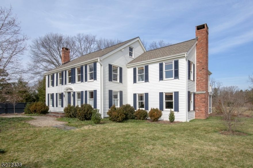 Charming New Vernon Colonial on 1.1 acres featuring wide plank wood floors and views of the preserved wildlife refuge. This updated home combines modern amenities with a functional and flexible layout. The main floor offers generously sized rooms, including family room, breakfast room, dining room, living room, and study. The kitchen features maple butcher block island, farmhouse sink, dual Wolf wall ovens, Wolf gas range, Carrara marble countertop, two refrigerators, and custom cabinetry including an appliance garage. The family room has a built-in bookcase and French doors to the screened porch as well as a wood-burning fireplace. The powder room and mudroom with built-in bench and shelves complete the first floor. The second floor features a spacious primary suite with sitting area, French doors to the balcony, four oversized closets, and ensuite bath. There are also three additional bedrooms, sitting room, hall bath, and laundry room on this level. The third floor offers a bright playroom with walk-in closets and window seat. A bluestone patio and walkway lead to the detached three car garage with office and exercise room above. The property contains perennial beds, wildflower meadow, and garden beds. New Vernon in Harding Township features pastoral scenery and access to nearby downtowns of Bernardsville, Basking Ridge, and Morristown with trains, restaurants, and numerous shops. Owner is a licensed realtor.