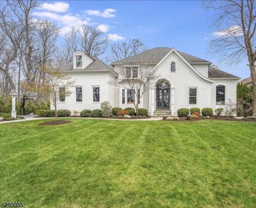 Architectural details + luxurious  amenities are evident everywhere in this custom French Manor home built by renowned architect Anthony James. Stunning home boasts 4000+ sq ft of living space, intricate millwork, paneled walls, high ceilings, floor to ceiling stone fireplaces and the MOST spectacular level yard with resort-like pool. Dramatic 2 story entry with paneled walls and oversized windows is flanked by a banquet-sized formal Dining Room and step-down Living Room. Incredible 1st flr Library with floor to ceiling millwork, bookshelves and a balcony. Custom Chef's Kitchen w/ chic gray cabinetry, high-end ss appliances, lg double-tiered center island. EIK is an open concept to the Family Room where both enjoy access to the rear "Southern " style porch, patio and pool. Garage features hydraulic lifts (room for 4 cars) and direct access to the Mud Room w custom built-ins and Laundry Room. Luxe Primary retreat w spacious Dressing Room, dual walk-in closets,  and spa-like Bath. 4 other bedrooms on this level are roomy, sunny with good closets. Lower Level with mini sports court, Media Room, gas FP,  gym w wraparound mirrors, and rubber floors & Kitchen area. Take the party outside to the 5 star resort style pool w covered porch, patio and plenty of room for soccer games. Rarely does a home of this caliber merge function + design so seamlessly. 958 Prospect St is a must see for buyers seeking a move-in ready custom home with on-trend finishes inside and out