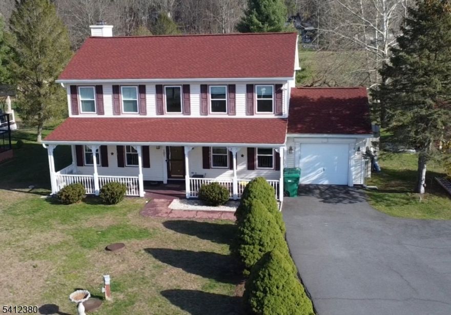 SPACIOUS 3 BEDROOM COLONIAL PERFECTLY SITUATED ON A FLAT 3/4 ACRE CORNER LOT! Major updates provide peace of mind, including a NEW SEPTIC SYSTEM (2023), NEW ROOF (2025), and NEW WINDOWS (2025). Located at the beginning of a quiet cul-de-sac, this property back to a large scenic pond and has exceptional outdoor space. A tree lined paved driveway provides ample parking, while the extra large welcoming front porch invites you inside. Step into a two story foyer leading to a thoughtfully designed main level with a living room, dining room, and a comfortable family room with a cozy gas fireplace. The large kitchen offers two pantries, ample cabinetry, and brand new sliders that open to the deck...perfect for indoor/outdoor entertaining. Upstairs, the large 23x14 primary bedroom includes a walk-in closet, and two additional generously sized bedrooms. Solar panels help offset electric costs, adding energy efficiency and long term savings to this exceptional home. Members enjoy a community pool, lake access, tennis courts, dog park, ball field and playground!!