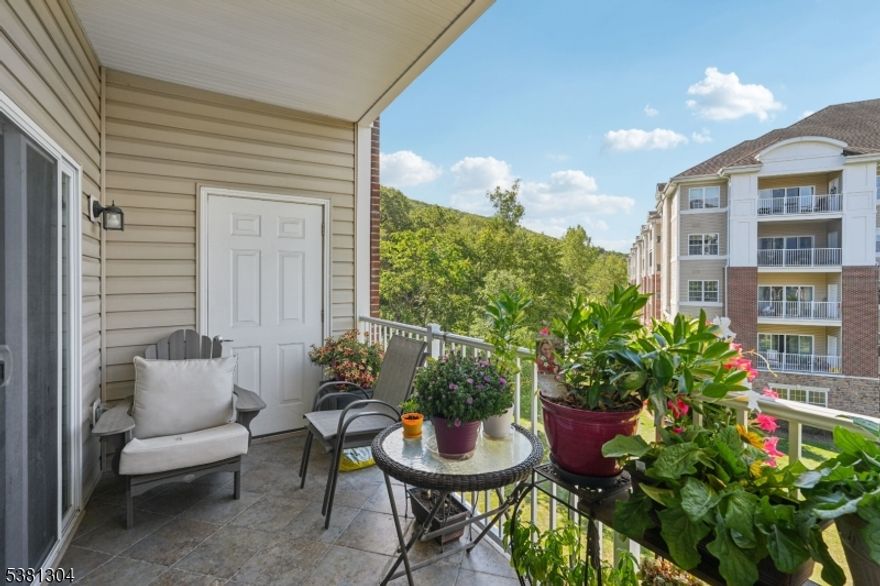 Welcome to this beautiful Colfax END-UNIT condo in one of the newer buildings of Wanaque Reserve, an active adult 55+ community. Move-in ready and filled with natural light, this 2-bedroom, 2-bath home offers picturesque views of the mountains and pond. The open floor plan features unique polished concrete floors, a spacious den with French doors that open to the dining room, and sliding glass doors that lead to a tiled balcony perfect for relaxing.The primary bedroom suite is a true retreat with a tray ceiling, walk-in closet, additional double closet, dressing area, and a private ensuite bath. A second bedroom, full bath, and in-unit laundry provide comfort and convenience. This home also includes TWO DEEDED UNDERGROUND PARKING SPACES. New hot water heater with auto shut off valve. Wanaque Reserve offers a resort-style lifestyle with a clubhouse that features a caf , fitness center, theater, sauna, ballroom, and both indoor and outdoor pools. With more than 45 clubs and activities, including travel, tennis, pickleball, golf, canasta, and poker, there is something for everyone. This property combines comfort, style, and community in one of the area's most sought-after locations.