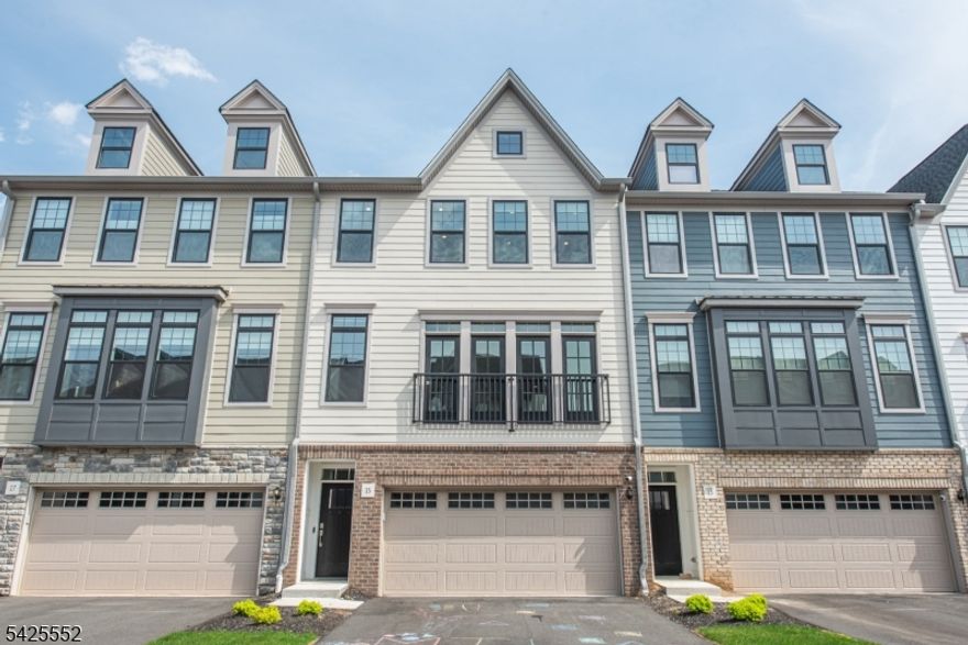 Welcome to The Grove at Upper Saddle River. This Briercliff model features extensive builder upgrades and backs to a private wooded setting. The open concept floor plan provides excellent natural lighting and is designed for both everyday living and entertaining, featuring a main-level office and a dining area with sliders to a deck. The kitchen offers a large center island, upgraded cabinetry, and full roll-out shelving for added convenience. Upstairs, the primary suite features a finished walk-in closet and a spa-like bath with a rain shower. Two additional bedrooms feature finished closets, and the hall bath includes a double sink vanity. A laundry room with added cabinetry completes the upper level. The finished lower level provides flexible living space with a recreation room that walks out to a paver patio, along with built-in shelving and space for a mini fridge. Upgrades throughout include custom hardwood flooring, iron rod railings, a stone fireplace, Sonos sound system, custom blinds, enhanced pantry shelving, and built-in garage storage. Excellent location - minutes from two train stations, bus stops, major highways, restaurants, shopping and entertainment. A perfect blend of style, function, and privacy move right in and enjoy.