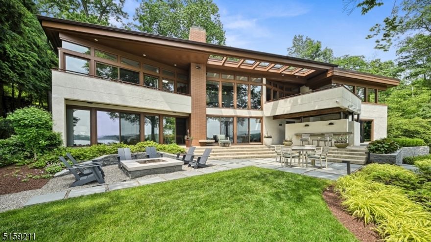 This absolutely stunning property presents an unparalleled combination of sophistication and refinement. The front facade of this classic modern work of art is purposely deceptive and understated... in contrast to the drama of the lakeside elevation with its striking views, bluestone patios and lush gardens. Collaboratively designed by a protege of the famed Frank Lloyd Wright, the architecture, design, and finishings are all carried out in impeccable taste and stand second to none. Walkout lower level office can easily become a 4th BR. Walls of glass seemingly disappear as one of NJ's most sought after private lake communities & its lifestyle become your very own. Some addl features include: custom refrigerated wine room, professional grade home gym, fully integrated Crestron smart home system, custom cherry millwork, whole house generator, int/ex audio, steel beam dock & so much more. Only 35 min to NYC. Schedule your private tour today!