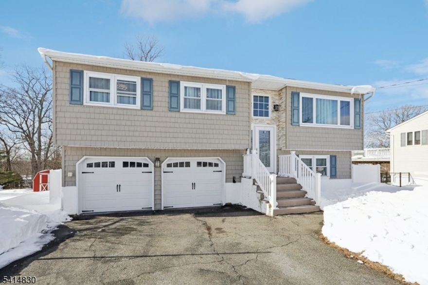 Beautifully renovated bi-level home offering 3 bedrooms, 2 full bathrooms, and a 2-car attached garage, located on a level lot just minutes from Lake Hopatcong. The main level features a bright open-concept layout with a spacious living and dining area, and an updated kitchen with quartz countertops, breakfast bar, and stainless steel appliances. You?ll also find three bedrooms and a beautifully updated full bathroom. Sliders from the dining area lead to an oversized deck with stairs down to your private, fenced-in backyard. The ground level offers a large family room with direct access to the patio and backyard, plus a full bathroom with laundry and additional storage. Enjoy winter lake views, central air, and public water and sewer. Conveniently located near major highways, transportation, and everything Lake Hopatcong has to offer, including boating, fishing, kayaking, skiing and more.