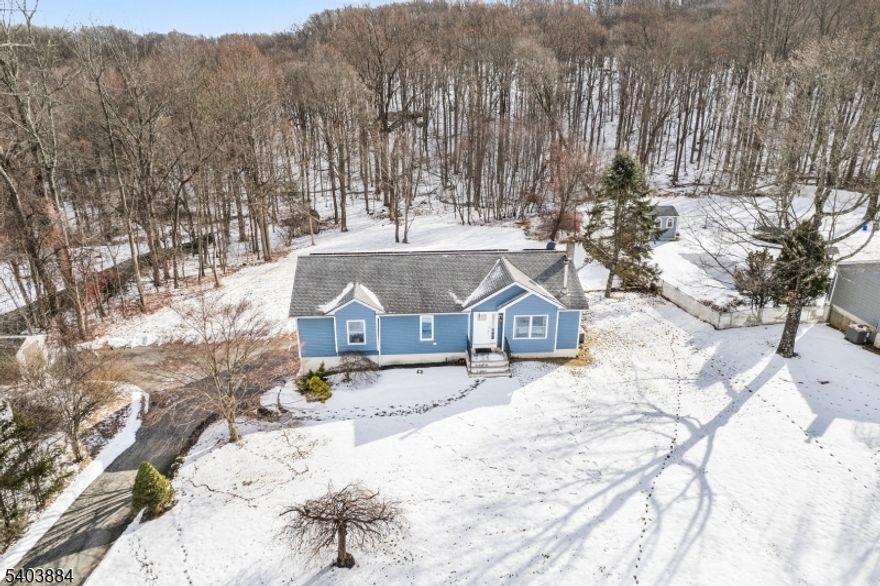 Beautifully updated 3-bedroom, 3 full-bath ranch set on over 1.5 acres of private, picturesque land in highly desirable Vernon Twp. This home offers the perfect blend of modern comfort and serene nature living just minutes from year-round recreation including Mountain Creek Resort skiing, hiking trails along the Appalachian Trail, golf, and convenient shopping and dining as well as a short ride to Warwick for wineries and dining. Inside, enjoy a bright open-concept kitchen and living area, ideal for both everyday living and entertaining. The living room features a cozy wood-burning stove, while the updated kitchen boasts a center island, modern finishes, and ample storage. The spacious primary suite is a true retreat, offering a full ensuite bath with dual vanities, a stall shower, walk-in closet, + charming Romeo & Juliet balcony. Two additional bedrooms + full baths provide comfort and flexibility. The fully finished, oversized walk-out basement adds exceptional living space and includes its own full bath, perfect for guests, home office, gym, or rec room. Step outside from the kitchen to a large deck overlooking the private backyard, ideal for entertaining or relaxing in a peaceful natural setting - with breathtaking sunsets!  Additional highlights include 2-car garage, patio from basement, expansive driveway, new furnace + new A/C condenser. A rare opportunity to enjoy space, privacy + modern updates while staying close to outdoor adventures and everyday conveniences.