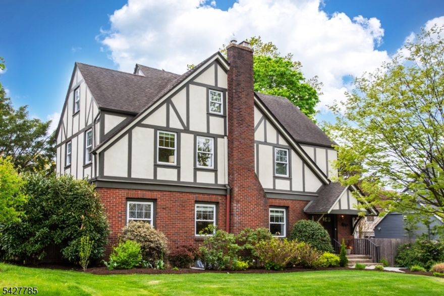 Impeccably maintained and thoughtfully updated, this substantial Craftsman Colonial offers the perfect blend of space, function, and location just moments from downtown Montclair and Bay Street Station. Generously sized rooms and an effortless first-floor flow make everyday living and entertaining a breeze. The oversized kitchen is a true standout, featuring a six-burner stove and expansive center island ideal for both casual meals, serious cooking and entertaining. A large living room and bright sunroom complete the inviting main level.Upstairs, the second floor boasts three light-filled bedrooms, a hall bathroom plus an impressive primary suite with an ensuite five-fixture bathroom and ample closets and built-ins for storing your year round wardrobe. Quarter and rift-sawn white oak floors and a two-story library nook add both character and charm. The third floor offers two additional bedrooms and a full bath perfect for guests or work-from-home suite.The finished basement provides flexible space for a game room, gym, or media area. Smart upgrades including a high-efficiency boiler, solar panels, and Tesla Powerwall help keep utility costs very low, year-round. Move right in and enjoy easy living in one of Montclair's most convenient locations.