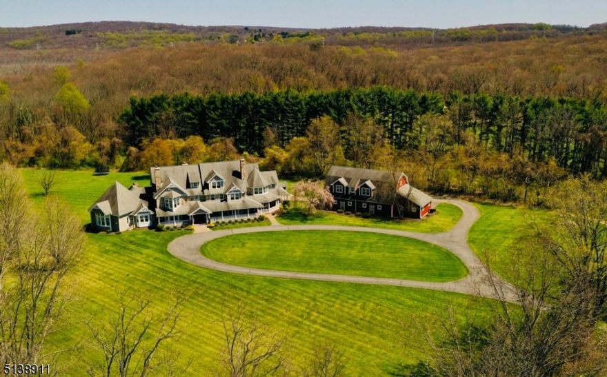 Welcome to "Black River Run," set on 10 park-like acres in serene Chester Township, this modern farmhouse is the perfect blend of function & beauty with over 9500 sf of living space with style and character at every turn.  Hardwood floors, six fireplaces, abundant natural light & the finest architectural appointments throughout create a warm & inviting vibe. The well-designed open floor plan & unparalleled attention to detail throughout the home is impressive. Rocking chair front porch & gracious entry foyer leads to living room with fireplace, library with fireplace, and formal dining room. At the heart of the home, the chef's kitchen with top of the line appliances is open to breakfast room and oversized family room with stone fireplace. Mudroom with custom built-ins, oversized first floor laundry.  Luxurious first floor primary suite with sitting room with fireplace, WIC, sunroom & spa-like bath. Second floor features 5 ample bedrooms, 3 full baths, second laundry, exercise room & walk-up attic. A 5 car barn with potential above for studio, guest apartment or the ideal place to work from home.  Geothermal heating and cooling.  One of a kind setting- backs to Black River Preserve parkland.