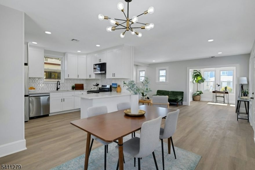 Renovated 3-bedroom, 3-bath home with finished basement, central air, driveway, and garage in Newark?s Upper Vailsburg section. This move-in ready property features a modern open layout with wide-plank flooring, recessed lighting, and abundant natural light. The living and dining areas flow into an updated kitchen with quartz countertops, shaker cabinets, stainless steel appliances, gas range, peninsula seating, and designer tile backsplash. A bright, window-lined front room offers flexible space for a home office, sitting area, or additional lounge. Upstairs includes three well-proportioned bedrooms, while all three bathrooms have been updated with large-format tile, modern vanities, and contemporary finishes. The finished basement with full bath adds valuable bonus space for recreation, work-from-home needs, or extended living. Additional highlights include central air conditioning, updated systems, private driveway, and detached garage. Conveniently located near major highways, shopping, parks, Seton Hall University, and public transportation with access to NYC and Newark Liberty International Airport.  A fully renovated Upper Vailsburg home offering modern updates, functional space, and long-term value.