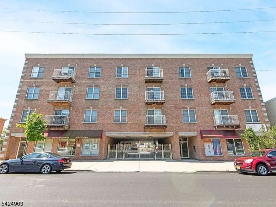 A wonderful opportunity to own in the highly desirable Chestnut Point Condominiums, ideally situated in Newark's sought-after Ironbound section and zoned for the highly rated Blue Ribbon Ann Street School district. This beautifully maintained unit offers the perfect blend of comfort and convenience, with easy access to major highways, mass transit, banks, shopping, restaurants, and local bakeries. The building features ground-level covered parking with direct access to the foyer and elevator for added ease. Located on the 3rd floor, this airy condo boasts an open-concept layout with a spacious living room and gleaming hardwood floors throughout. The kitchen is equipped with custom wood cabinetry and updated appliances, seamlessly overlooking the living area and private rear balcony, perfect for relaxing or entertaining. The luxurious primary bathroom features a glass-enclosed shower, soaking tub, and double vanity. Both bedrooms offer generous closet space and windows facing Chestnut Street, providing natural light throughout the day. A convenient in-unit laundry closet completes this well-appointed home.