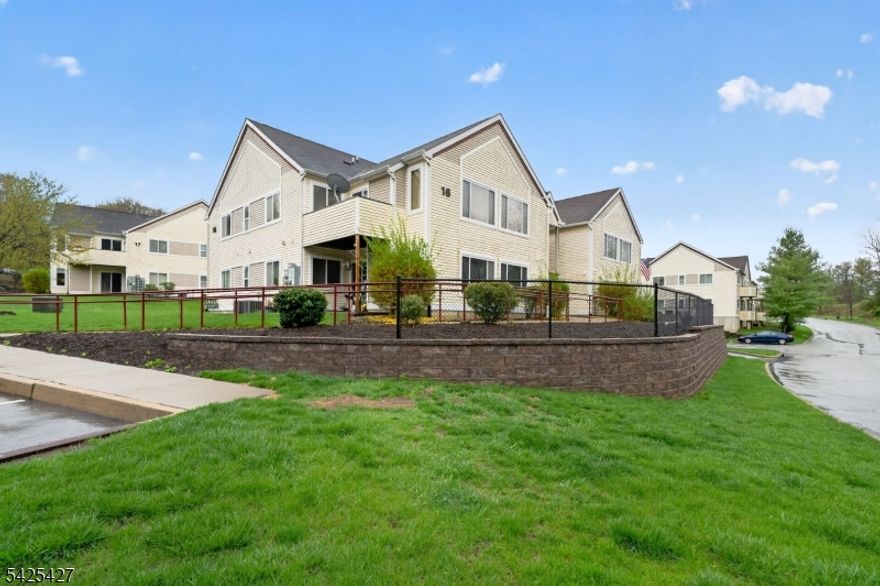 OPEN HOUSES CANCELLED. Welcome to this Beautifully Maintained and Move in Ready 2 Bedroom 2 Full Bathroom Condo in Falcon Ridge.  Step right into the Open Floor plan with Vaulted Ceilings in the Living Room with Gas Fireplace and Sliders to the Deck, Separate Dining Room, and Kitchen with Peninsula Seating.  Down the hallway you will find the spacious Master Bedroom with a Walk in Closet and En-Suite Bathroom.  The 2nd bedroom has ample closets with the 2nd bathroom across the hall.   Bonus - The washer and dryer are located in the kitchen inside the cabinets for seamless functionality.  The beautiful new carpet throughout and a New A/C unit was installed in 2025.  Located at the end of the complex and within walking distance to the Clubhouse and Swimming Pool.