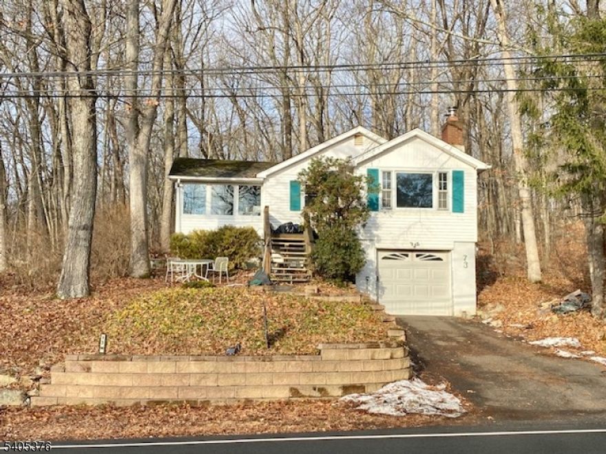 A rare opportunity in the desirable Lake Shawnee community! Set on an uncommon half-acre lot, this three-bedroom, one-bath home offers solid bones and exciting potential for the buyer ready to add their own vision, creativity, and TLC. The sun-filled breakfast room features vaulted ceilings, a wall of windows, and a door leading directly to the rear patio, creating a wonderful connection between indoor and outdoor living while offering seasonal lake views. The home also offers hardwood floors and a cozy wood-burning fireplace in the living room, adding warmth and character. An unfinished basement with a laundry area provides excellent potential for future finished space, while additional attic storage adds to the home's functionality. The one-car garage includes a new garage door opener, and recent updates such as newer retaining walls enhance the property's appeal and usability.Enjoy exceptional privacy, with no immediate neighboring homes and a wooded backdrop behind the property   a rare find within a lake community. Lake Shawnee residents enjoy members-only amenities, including a clubhouse, sandy beaches, playgrounds, basketball and volleyball courts, boating, fishing, and more. Whether you're seeking a renovation project, an investment opportunity, or the chance to create your dream retreat, this property delivers land, location, and lifestyle in one compelling offering.