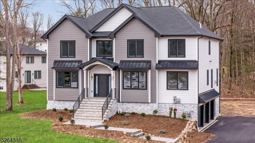 Stunning, bright, NEWLY CONSTRUCTED Colonial with a sleek blend of classic and contemporary finishes on tree-lined property in West Milford just minutes from dining, shopping, parks and more, with 5 bedrooms, 4.5 baths, an office, 3-car garage and an inviting floor plan. A portico front entry leads you inside to a gracious interior highlighted by spacious, open floor plan, high ceilings, elegant details, hardwood floors, crown molding and recessed lighting throughout. The 2-story foyer is flanked by a sunny living room and a dining room with adjacent butler's pantry with a wine fridge. Just beyond is an incredible, sun filled open kitchen and great room ready for relaxing and entertaining. This gorgeous chef's kitchen has ample white cabinetry, quartz counters, center island and high-end appliances, while the great room features a gas fireplace and wooded backyard vistas. A private office/den and discreet half bath off the living room complete this level. Upstairs, you'll find a generous primary suite with huge walk-in closet and luxurious bath boasting a dual vanity, soaking tub and oversized shower, as well as 4 more big bedrooms, two full hall baths, and convenient laundry. A finished lower level offers a sprawling rec-room/play room space with walk-out to the patio and backyard, plus a bonus 4th full bath, utilities, storage and access to the attached 3-car garage. Everything's new and with warranty, nothing to do but unpack and enjoy!