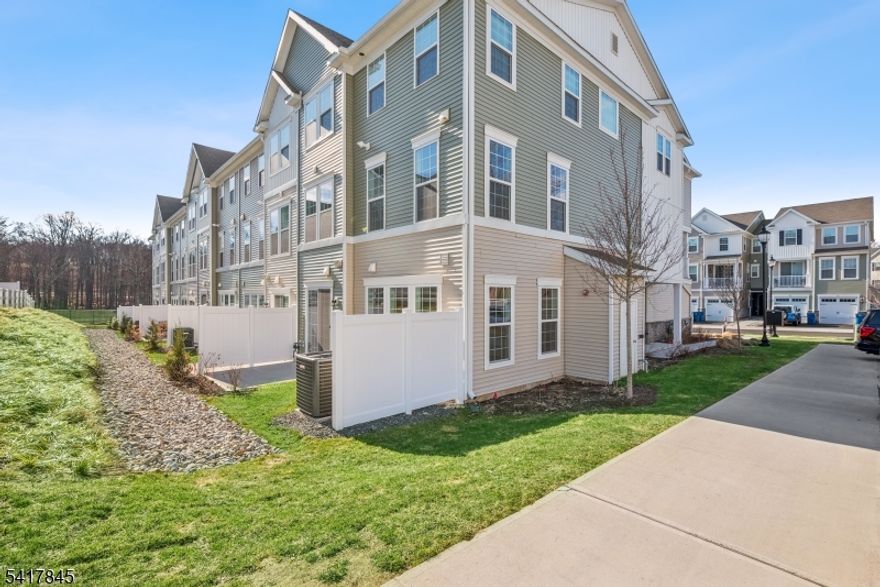 Brand-New, never-lived-in corner end-unit townhome loaded with premium upgrades and modern luxury finishes. This 2-bedroom, 3 full-bath home features a sun-drenched open layout, dramatic floor-to-ceiling windows, and 9-foot ceilings that create a bright, airy living space designed for today's lifestyle. High-end details throughout include wide plank engineered hardwood flooring, oversized baseboard moldings, designer tile work, and abundant storage solutions. The chef's kitchen is built to impress with sleek white cabinetry, quartz countertops, GE stainless steel double oven, a custom vent hood, and a large center island perfect for gathering and entertaining. Sliding glass doors open to a private patio, offering effortless indoor-outdoor living. The main level also includes a full bath and direct garage access for everyday convenience. Upstairs, retreat to a spa-inspired primary suite featuring upgraded porcelain flooring, a frameless glass shower with rain shower head, double vanity, and a custom walk-in closet. A spacious second bedroom, additional full bathroom, and second-floor laundry complete the upper level. Bonus features include a tankless hot water heater, built-in air purification system, and a full luxury upgrade package with today's most desirable modern amenities. Prime location in a sought-after town with top-rated schools, shopping, dining, and easy access to major highways.