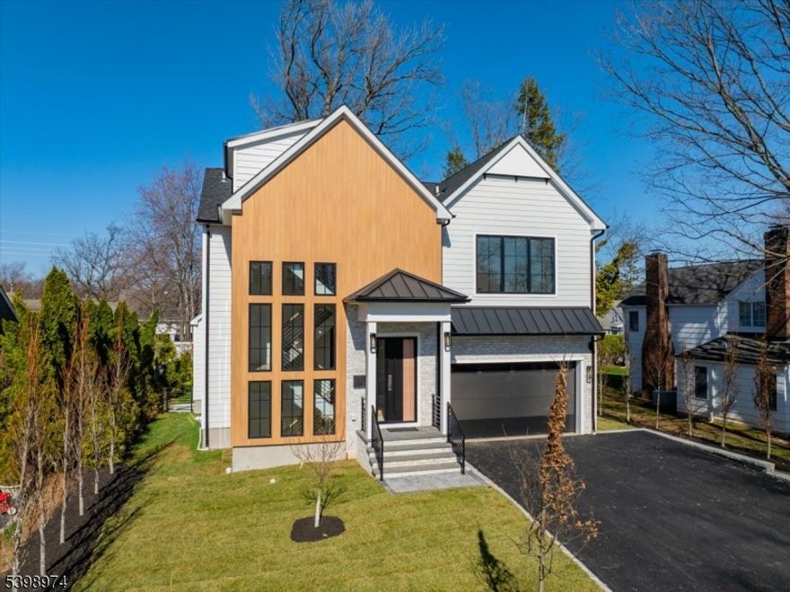 Fully completed new construction. Move in immediately and experience exceptional value at $575 PPSF, well below Westfield's $630 PPSF new construction average. This stunning 6BR/6-BA + Loft home by NJGCB offers four levels of thoughtfully designed living space, blending elevated design w/superior construction. Built with 9' ceilings on every level, engineered framing, and a double French drain system with full waterproofing, this home delivers both luxury and long-term peace of mind.The chef's kitchen is a standout, featuring custom White Oak cabinetry, Taj Mahal quartz countertops, a 7-foot waterfall island, and a full Viking appliance package. It opens seamlessly to a sunlit family room with a Taj Mahal quartz fireplace wall and white oak flooring throughout. A flexible layout includes a first-floor ensuite bedroom, ideal for guests or private office space. Upstairs, the primary suite offers a spa-like wet room with Kohler fixtures, rainfall shower, and heated bidet, along with a tray ceiling and generous closet space. Additional bedrooms span the second, third, and lower levels, including multiple ensuites and a finished walk-out basement w/full bath. Andersen 400 black windows, Sprinkler system, multi-zone HVAC, and a paver patio complete the home. Located just minutes to top-rated schools, downtown Westfield, and NYC transportation, this is a rare opportunity to own a fully completed, design-forward home w/immediate availability and unmatched value. Do not miss out.