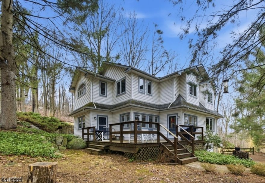 Set on over 1.6 acres of private property, this charming older home located in Montville, blends classic character with thoughtful updates while offering the convenience of nearby shopping, dining, and easy access to major highways.  The second floor was completely remodeled in 2000, creating a spacious and comfortable layout designed for modern living. The highlight is the massive primary bedroom retreat featuring soaring vaulted ceilings that enhance the sense of space and natural light. The en-suite bath offers a spa-like setting with a separate shower and soaking tub and double vanity. The second level also includes a convenient laundry room and two additional bedrooms.  The first floor features a welcoming living room, spacious dining room,  updated kitchen with breakfast nook, warm den/library with a wood-burning fireplace, powder room, and a private office, providing flexible space for a variety of uses.  Home sits on a quiet dead-end street providing exceptional privacy and space to enjoy the natural surroundings. Additional exterior features include oversized deck for outdoor entertainment, all new thermopane windows and maintenance-free vinyl siding, combining efficiency with easy upkeep.