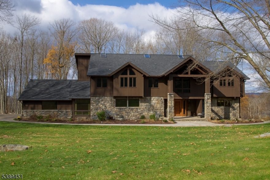 Nestled on a private cul-de-sac, this exceptional home blends Colorado resort-style living in Sussex Mills minutes away from Lake Mohawk. The gourmet kitchen features granite countertops, pantry, premium GE Caf  appliances, smart French-door refrigerator, and a 36" commercial-style gas range. The open floor plan flows to a large dining room with wet bar overlooking a sunken living room, ideal for entertaining. The first floor offers a private guest suite with full bath and walk-in closet, plus a second bedroom that can also serve as an office.The second-floor primary suite includes a walk-in closet, slate walk-in shower, and a striking 72" clawfoot copper tub. Additional upstairs bedrooms are generously sized, each with walk-in or double closets, along with a loft and bath. The lower level features an Irish pub"style space with custom bar, fully equipped kitchenette, slate bath, gym area, pool table space, and media area.Smart-home features include WiFi-enabled thermostats, lighting, and security. The backyard retreat offers a natural gas heated gunite pool, hot tub on bluestone base, Techo-Bloc pavers, natural stone stairs, fire pit, metal fencing, and deck. Recent improvements include new roof, commercial skylights, four high-efficiency HVAC systems, whole-house water filtration, exterior stone work, walkways, and whole house natural-gas conversion. This remarkable property offers privacy, style, and state-of-the-art amenities in one of Sparta's most desirable settings.