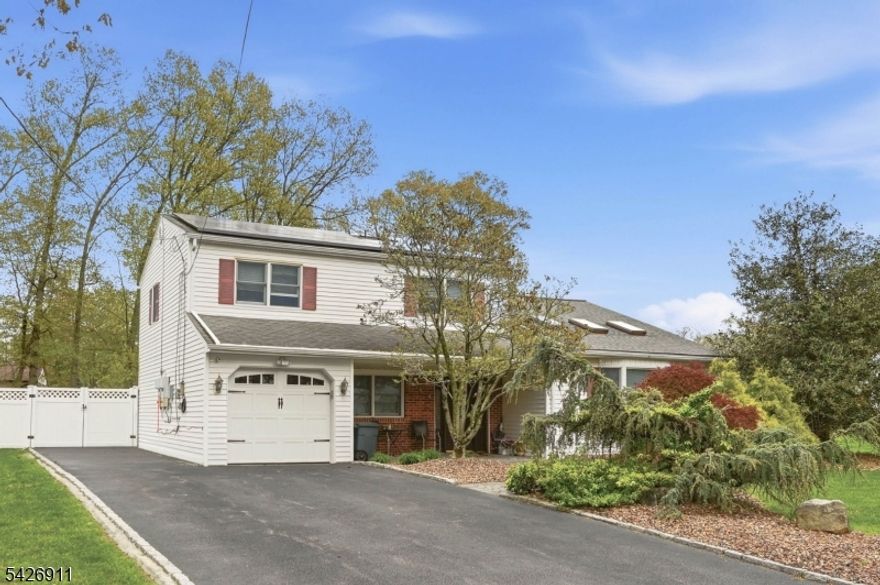 Beautifully maintained 4-bedroom home located in a highly desirable Parsippany"Troy Hills neighborhood, set on a generous 0.44-acre lot. This inviting residence features an open floor plan with a seamless flow between the main living areas perfect for everyday living and entertaining. The skylights in the living room with vaulted ceiling add  to the natural light in this stunning room. The eat-in kitchen offers ample cabinetry and space for casual dining, while the formal dining room with adds charm and natural light for more elegant gatherings. The main level is complemented by spacious bedrooms and comfortable living areas throughout. The lower-level family room with sliders to the patio provides additional living space ideal for relaxing, and  recreation and the 4th bedroom offers a home office setup. Enjoy outdoor living on the gracious deck, overlooking the expansive backyard with plenty of room for activities or future enhancements. Additional highlights include a one-car attached garage and a well-sized property offering both privacy and convenience. Close to major highways, shopping, dining, and all that Parsippany"Troy Hills has to offer.