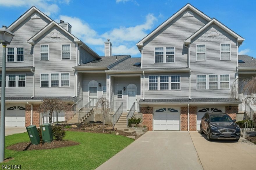 Welcome to this beautifully maintained townhouse in the desirable Oak Hill community of Independence. This charming home features 2 bedrooms, 1.5 bathrooms, a one-car garage, and a finished basement. A stunning two-story foyer with a chandelier welcomes you inside, filling the home with natural light. The formal living and dining room combination, complete with a cozy wood-burning fireplace, flows seamlessly into the kitchen. The kitchen offers stainless steel appliances, a pantry, breakfast bar, and an eat-in area that opens to a deck with stairs leading to the backyard, perfect for relaxing or entertaining. Upstairs, a loft-style foyer overlooks the kitchen below. The spacious primary bedroom includes a walk-in closet, accompanied by a generously sized second bedroom and a full bathroom. The finished basement provides additional living space with a recreation room, laundry, utility room, extra storage, and direct access to the car garage. Newer water heater, dishwasher, microwave and washer. Conveniently located less than one mile from Hackettstown Hospital, and close to shopping, restaurants, and the Hackettstown train station. Easy access to Routes 80, 46, 57, and 206. HIGHEST & BEST OFFERS DUE ON TUES 4/28 AT 12 NOON
