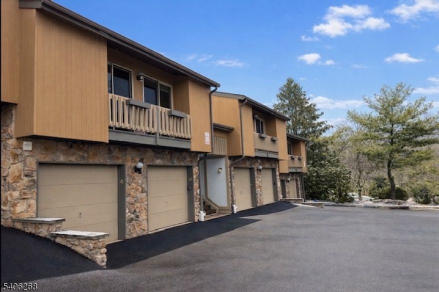 Welcome to Scenic Hill, one of West Orange's most desirable condo communities, offering comfort, convenience, and resort-style amenities. This first-floor one-bedroom, one-and-a-half-bath residence features hardwood floors throughout, a gas fireplace anchoring the living room, and a versatile den ( think tv room, yoga space,  home office, guest room) with sliders leading to a private patio perfect for relaxing or entertaining. The kitchen offers tile flooring, and the spacious primary bedroom includes double closets and an updated private bath. A powder room, in-unit laundry, and direct access to a one-car garage add everyday ease and functionality. Scenic Hill residents enjoy a seasonal swimming pool, exercise room, clubhouse, tennis and pickleball courts, creating a true community feel with recreational options right outside your door. Ideally located near Route 280 and major commuting routes, this home offers quick access to NYC-bound transportation, and all that Essex County has to offer. West Orange is known for its beautiful county parks, including the nearby South Mountain Reservation, Turtle Back Zoo, golf courses, parks, and a vibrant mix of shopping, dining, and cultural attractions. A rare opportunity for first-floor living with garage access, outdoor space, and amenities all in a prime West Orange location.