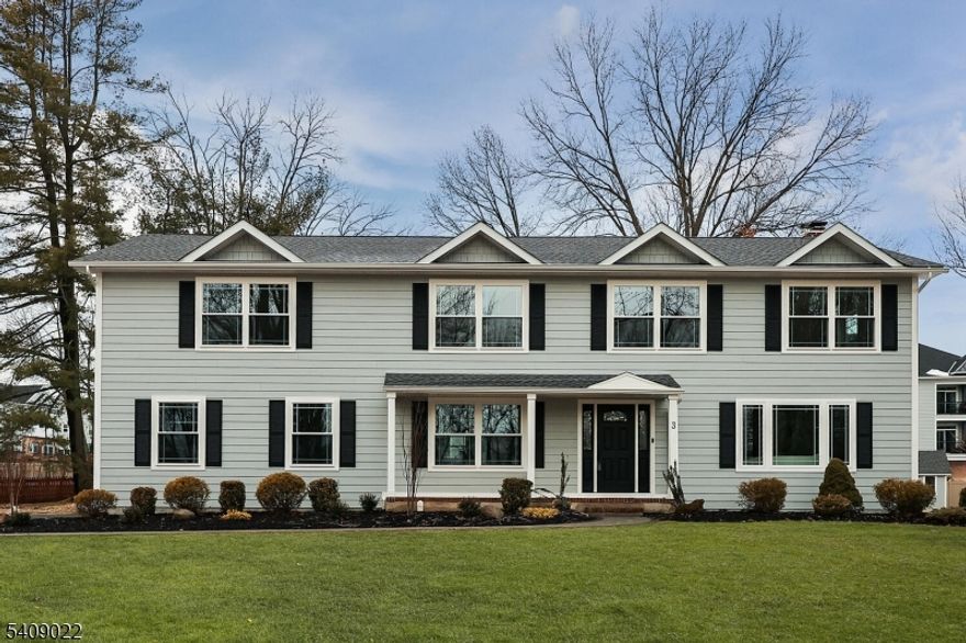 Discover exceptional design and superior craftsmanship in this stunning 5-bedroom, 3.1-bath home, where every detail has been thoughtfully curated to blend luxury, comfort, and modern functionality. An inviting open front porch welcomes you to a home wrapped in durable Hardie Plank siding and enhanced by professional landscaping, a front and a spacious deck ideal for outdoor entertaining and year-round enjoyment. Step inside to a bright, open floor plan showcasing refined finishes, timeless style, and custom closets throughout. The heart of the home is the chef-inspired kitchen, featuring premium Thermador stainless steel appliances, custom soft-close cabinetry, sleek quartz countertops, and a center island with seating. The adjacent dining area is perfect for gatherings, while the family room with a classic wood-burning fireplace creates a warm, inviting atmosphere. A living room, mudroom with built-ins, and powder room complete the first floor. Upstairs, the expansive primary suite offers a vaulted ceiling, walk-in closet, and spa-like bath with soaking tub, stall shower, and dual-sink vanity. Four additional spacious bedrooms, two full hall baths, and a generous laundry room complete the second level. The full, finished lower level provides  even more living space with a large recreation room and play area. Ideally located minutes from schools and parks, this home offers both convenience and unparalleled style.Taxes do not reflect renovation.