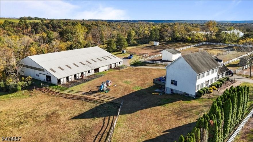 Well-appointed horse farm set on nearly 12 acres, featuring a 7-stall barn and a 70' x 120' indoor riding arena, ideal for year-round training and riding. The barn is equipped with a heated tack room with bathroom and laundry, along with a hot/cold wash stall for added convenience. Electric and water service to all pastures support efficient daily care and ease of management. Enjoy scenic trail riding throughout the property, with trails winding down to a peaceful creek perfect for conditioning rides or leisurely hacks. A thoughtfully designed equestrian property offering both functionality and versatility, ideal for training, boarding, or private equestrian use. The property features a 4-bedroom, 3.5-bath colonial home with new laminate flooring and fresh paint throughout (2021). The fully finished walkout basement provides additional living space and a full bathroom. This dream country retreat is just minutes from the charming river town of Frenchtown, known for its sought after schools, quaint shops and highly rated local favorite dining. The farmland assessment application has been submitted by the current owners, new buyer to coordinate permanent plan with tax assessor.