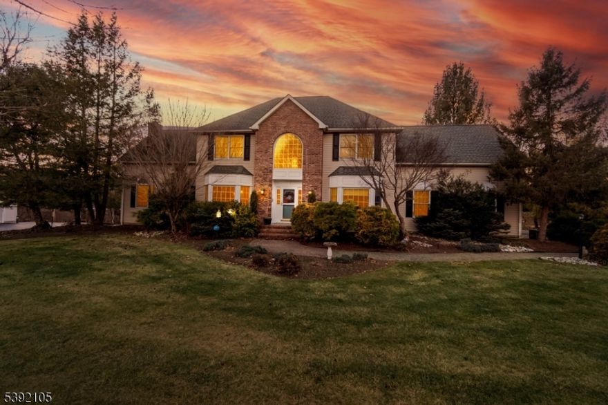 Privacy. Space. A setting that feels like a retreat. Tucked along a quiet stretch in the sought-after Kennedy Mills Estates, this beautifully maintained center-hall Colonial offers the kind of privacy and space buyers rarely find. Set on 2.37 acres backing to the trout-stocked Pohatcong Creek, the property feels peaceful and secluded while remaining close to I-78 and nearby NYC bus and rail service. Built by the original owners in 1997, the home offers approximately 3,633 square feet with four bedrooms, two and a half baths, and a three-car garage with extended-height doors. A welcoming foyer introduces a layout designed for comfortable everyday living and effortless entertaining. The spacious eat-in kitchen features granite countertops, center island, five-burner gas cooktop, double wall ovens, and stainless steel appliances. Hardwood floors lead to the formal dining room with bay window, while the dramatic two-story family room is anchored by a floor-to-ceiling brick wood-burning fireplace. The first floor also includes a private office, laundry room, powder room, and generous storage. Upstairs, the primary suite offers a tray ceiling, walk-in closet, and spa-like bath with double sinks, jetted tub, and tiled shower. Outdoor living feels like a private retreat with an oversized deck with retractable awnings, heated saltwater pool, patio, and landscaped gardens. Showings welcomed and easy to schedule.