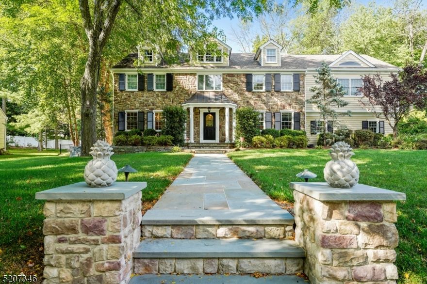 This meticulously maintained home is in the HEART of WICKHAM WOODS in Chatham Twp. This stately stone front colonial located in the MOST desired neighborhood within the twp is on almost 1/2 an acre of well manicured land & offers 6 BR (with bonus possible 7th) and 3.5 baths.The elegant, comfortable main floor offers an excellent flow and is complemented by wide doorways, generously sized rooms and architectural details such as crown molding, pocket doors, built ins and hardwood floors. The fabulous eat in kitchen is the heart of this home, with its oversized island, eating area, stainless steel appliances and connectivity to the rest of the main floor. Enjoy the lovely porch that overlooks an inviting, quiet, fully fenced in flat backyard with mature trees. Offering both an open & covered area, the porch and deck are timeless features that provide opportunities for relaxation and outdoor entertaining Driveway is gated for add'l privacy.  Oversized DR with double chandeliers & gas fireplace. Retire into the huge family room with game area, bar & FP. Oversized mud room with built ins & back entrance, sunny LR and powder room round out the main floor. On the second level you will find 6 BR's. The primary suite is light & airy with vaulted ceilings, 2 closets, bathroom with frameless glass steam shower. 5 additional BR's are spacious and have ample closets. 2 hall baths, 2nd floor laundry.  RARE 3rd floor walk up offers sizable, bright finished space! Fully finished basement!