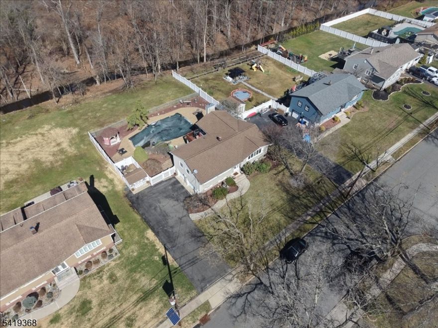 Where everyday living meets a private backyard escape, welcome to 49 Laguna Drive in Wayne, NJ. This beautifully maintained 3-bedroom, 3-bath bi-level home is thoughtfully designed for both comfort and entertaining. The main level offers a seamless flow from a sun-filled living room to a formal dining area and an oversized kitchen island, creating a central gathering space.The backyard is a standout feature, offering an in-ground pool, hot tub, outdoor sauna, and multi-level decking?ideal for relaxation and entertaining. The finished lower level adds versatility with a dedicated theater room.Additional highlights include a heated two-car garage, an expansive driveway accommodating six or more vehicles, and a durable 50-year roof.49 Laguna Drive offers a unique blend of space, functionality, and outdoor living?luxury at every price point.Property is located in a designated flood zone; seller reports no history of flooding during ownership. The fireplace and pool are being conveyed in as-is condition. 24-hour notice required. All appointments must be confirmed before access.