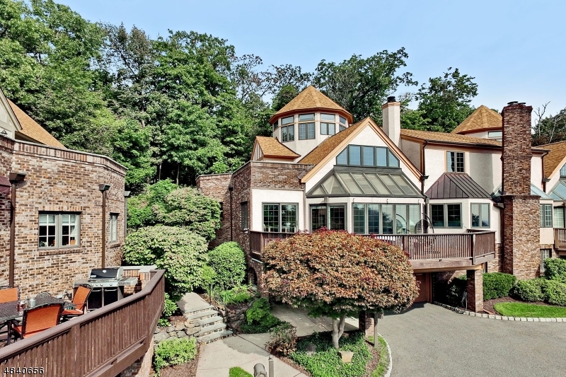 Enjoy stunning year round skyline views from all levels! Nestled up against the Kips Castle grounds, this town home offers privacy and luxury living at the finest level. Renovated to perfection! Guests are welcomed to foyer w dramatic split staircase. Two-story windows in LR & DR usher in magnificent natural light. Gourmet kitchen is equipped w high end ss appliances including Wolf range & SubZero fridge, granite & breakfast rm. Enjoy skyline views from wrap around deck. 1st flr MBS boasts gas fireplace, 4 closets & sumptuous BA w steam shower, 2 vanities & deep jetted tub. Up levels are sun drenched offering 2 BRs w ensuite BAs, den & access to balcony on 2nd & add'l  BR on 3rd. Ground Level features large FR w gorgeous built-desk, impressive wine cellar & laundry. Elevator will escort to all levels.