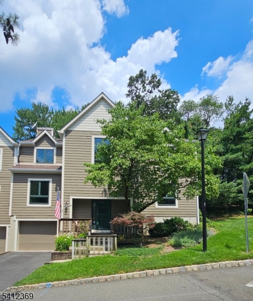 Welcome to this updated light-filled end unit offering a beautifully maintained living space. Spacious home features 2 bedrooms, 2.5 baths, 2 double-sided gas fireplaces, skylights, updated bathrooms, a second-floor laundry room, tastefully finished ground level, and an oversized one-car garage. Designed for comfort and flexibility, the home offers a family room, living room, and generous recreation room perfect for spreading out, entertaining, or work-from-home needs. The inviting kitchen boasts high-end cabinetry, granite countertops, tiled backsplash, and sunny breakfast area that opens to a private deck. One double-sided fireplace warms both the living room and adjacent family room, while the second adds ambiance to the primary suite. The primary suite impresses with vaulted ceilings, a separate sitting room, skylights, and updated bath featuring a soaking tub and separate stall shower. The ground level offers high ceilings, a spacious recreation room ideal for a media or game setup, and an office/guest room. Recent upgrades include a new HVAC system (2018) with upper-level splits, a new roof with skylights, and a new refrigerator and hot water heater. Ideally located atop Garret Mountain, this home offers a perfect blend of tranquility and convenience. Commuting to NYC is easy with multiple options nearby. You'll also enjoy convenience of supermarkets nearby, along with close proximity to Montclair's renowned dining, shopping, and roadways. Flues and chimney "as-is".