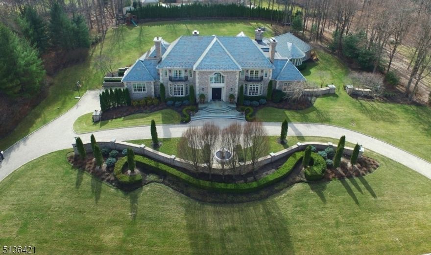 Luxury Built Brick Estate Home with a Slate Roof & Set on 2 Acres. Hand carved mahogany doors. 2-story marble foyer with dual bridal staircase. Warm & inviting living room & elegant dining room, both with fireplaces. Magnificent great room, fireplace & built-in cabinetry & wall of windows overlooking the grounds. Uniquely designed bar room with a wet bar with access to patio and perfect for indoor & outdoor entertaining. Office on the 1st floor with fireplace. Upscale kitchen with top-of-the-line appliances is one-of-a-kind & perfect for a chef. Adjoining the kitchen is a very light & bright breakfast room with fireplace. In a separate wing there is a spectacular indoor pool & spa with fireplace for year round entertaining & has multiple French doors opening to the patio. Beautifully appointed primary suite with fireplace, private staircase, custom closets & lavish bath. Lower level has media room, family rm, gym & bath. 5 car garage. Rio Vista amenities:pool/tennis/gym/clubhouse.