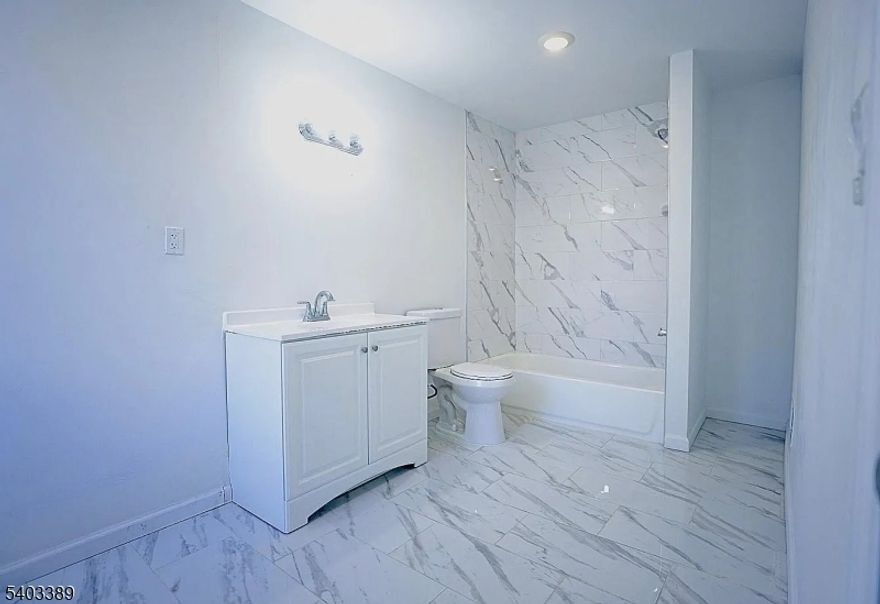 Spacious 3-bed 2-bath, newly painted and renovated with modern finishes, central AC, and heat. Located in a quiet residential area of Upper Clinton Hill, between Madison and Clinton Ave., close to school and public transportation. The kitchen features ample cabinetry and counter space, perfect for everyday cooking. The primary bedroom includes a private en-suite bath for added convenience, while two additional bedrooms are generously sized with ample closet space. Both bathrooms are tastefully finished, and the apartment offers abundant natural and recessed light throughout. Conveniently located near transportation, and easy access to local parks, schools, shopping, and major commuter routes such as I-78 and the Garden State Parkway. Newark Liberty International Airport is close by, and multiple NJ Transit options make travel to NYC simple and convenient. The home is also within minutes of Beth Israel Hospital. This apartment is an excellent place to call home. Some pets allowed.