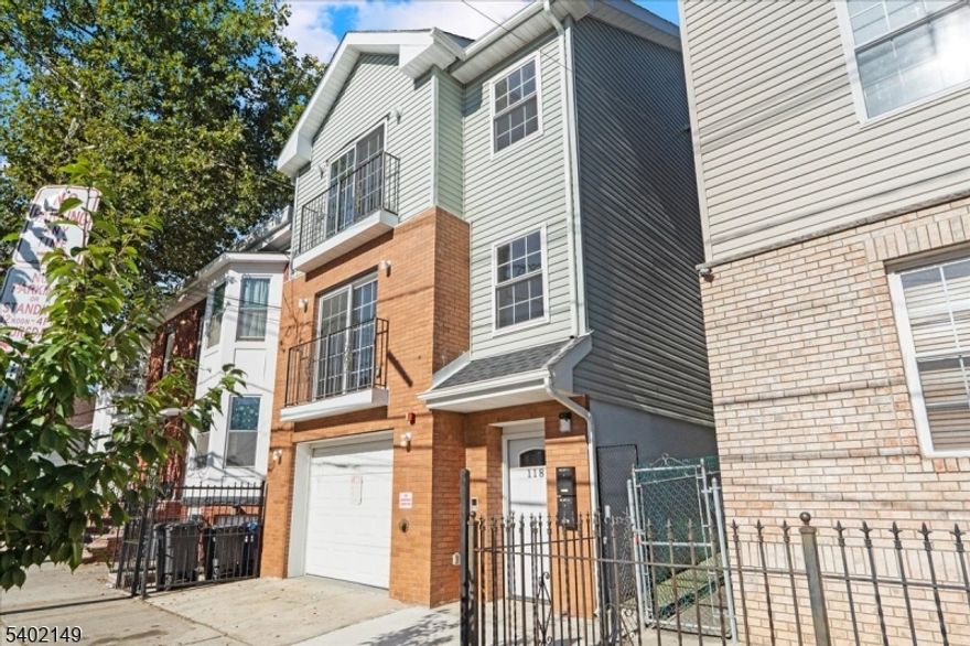 Exceptional new construction two-family home completed in 2022, ideally located in Newark's North Ward, just off Broadway and between Chester & Delevan Avenues, near the Belleville border. Although currently fully occupied, this property is a true ground-up build, not a renovation.Unit 1 offers a spacious, modern layout spanning the second floor, featuring a bright open-concept living and dining area, contemporary kitchen with stainless steel appliances, two well-sized bedrooms, and a full bath. In addition to the main living area, Unit 1 benefits from access to a fully finished walkout lower level, providing valuable additional finished space that includes a laundry area, half bath, and direct exterior access.This level is complemented by an exceptionally upgraded built-in garage, rarely seen finished with vinyl flooring, clean walls, and excellent lighting offering a highly versatile extension of the home suitable for storage, workspace, or other permitted uses.Unit 2, located on the third floor, mirrors the modern finishes found throughout the home and features an open-concept layout, stainless steel kitchen appliances, two generously sized bedrooms, a full bath, ample closet space, and pull-down attic storage.