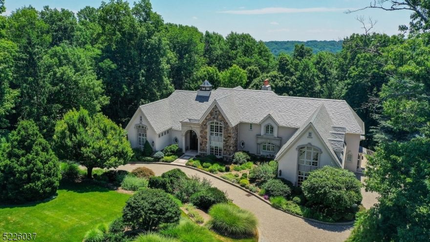 Rare chance to own an exquisite architectural gem, designed for exceptional living.  No detail or amenity is overlooked in this 6 BR, 5.1 BA estate nestled in the Watchung Mountains w/ maximum privacy & majestic views from every level.   Endless entertaining & relaxation awaits w/ grand 3-story, one of a kind circular staircase, fully temperature controlled 4-season conservatory complete w/ a grill, TV & auto rain sensor skylights, an indoor swimming pool & 3 zone surround sound system.  First floor primary suite is an ideal place to retreat w/ vaulted ceilings, mountain views, gas fireplace, sitting area, expansive en-suite w/ jacuzzi tub, heated floors, dual closets & private access to the library.  Opulent 2-story fireplace in sunken living room is a timeless classic.  Updated baths May 2023. Additional guest BR w/ full bath is conveniently located on the 1st floor.  Dual staircases lead to the upper level that boasts a large sitting room & 4 additional BRs-1 en-suite & 1 jack and jill.  Finished lower level is highlighted by access to heated indoor pool, 2 walk-out access points to patio areas, movie theater, bar, space for hobbies & storage, full bath & 2nd laundry room.  Meticulously manicured lush & mature landscaping is a nature lover's dream.  Whole house generator, heated circular paver driveway, sprinkler system & roof, allow for added comfort & minimal outdoor maintenance.