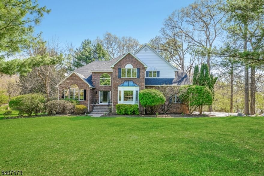 Tucked away on a quiet cul-de-sac,this exceptional 4-bedroom residence offers a rare blend of privacy,space & understated luxury. Three bedrooms and an office are located on the 2nd level. On the 1st floor is the 4th bedroom. Another office is located in the basement . A sun-drenched two-story foyer makes an immediate impression,that leads into a dramatic living room w/vaulted ceilings & an abundance of natural light. The grand bank of windows allows the outdoors in.This home is perfectly suited for both intimate moments and sophisticated entertaining. At the heart of the home, is a beautifully appointed kitchen that flows seamlessly into the family room creating an effortless open-concept design that appeals to many. The finished walkout lower level extends your living space, opening to a lush backyard ideal for relaxing, or creating your own wellness retreat. From the family room step outside to a deck overlooking a serene wooded setting offering a daily escape that feels worlds away from all of the busyness. Thoughtfully updated w/hardwood flooring, fresh designer paint, a new roof, and a newly paved driveway, this home delivers a true move-in-ready experience.Located just minutes from premier shopping,dining & commuter routes perfectly balances seclusion with accessibility. Adding to its long-term appeal, the local high school is among the select few in NJ to offer the prestigious International Baccalaureate (IB) program providing a true long term academic advantage.