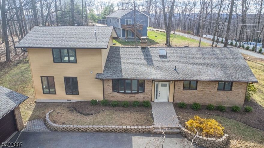 This is the one you've been waiting for! Stunning, fully remodeled 3-bedroom, 2.5 bath custom home srt on over 2 private acres of picturesque property. Step into a designer kitchen featuring stainless appliances and sleek quartz countertops, perfect for everyday living and entertaining. The brethtaking living room offers vaulted ceilings and a gorgeous fireplace, creating a dramatic yet inviting space. Escape to your private second-floor primary suite-your own peaceful retreat. A bright and spacious sunroom leads to a deck overlooking the expansive property, ideal for indoor-outdoor living. Complete with an oversized 2-car garage and brand-new roo, this home truly has it all. Nothing to do but move right in and enjoy luxury living at its finest!