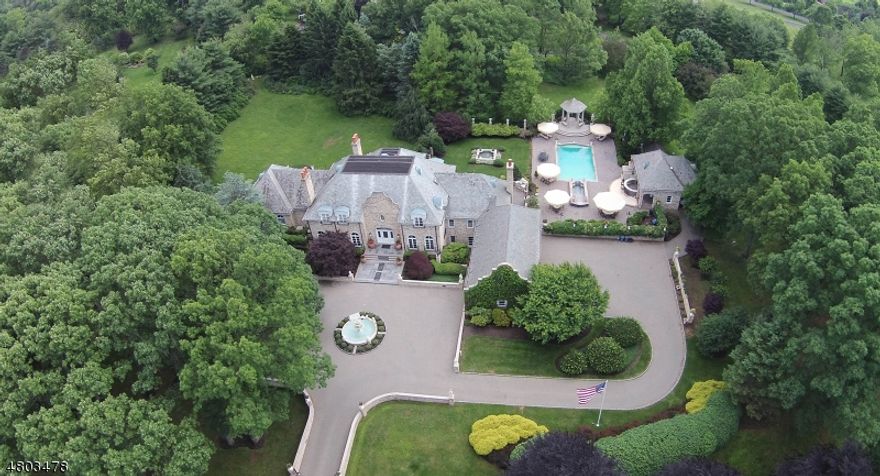 Distinctive French Manor home with resort-style property in one of New Vernon's most desirable locations! With every amenity, spectacular new Leonardis Kitchen (2008) with state of the art appliances, totally open to the Family Room. A 1st floor master suite with 2 spa-like bathrooms & sitting room. Gated and fenced private grounds on cul-de-sac. Slate roof, all brick siding. 2 story foyer, billiard room, multiple sets of Mahogany French doors, hardwood floors, 3 of 5 bedrooms are en suite. Beautifully finished full walk-out lower level. Cedar closet/room. Lush abundant landscaping, fountains, walls, paver stone courtyards and terraces. Incredible pool with jetted spa, columned limestone gazebo, newly renovated pool house with dining terrace, kitchen, bath, lounge.