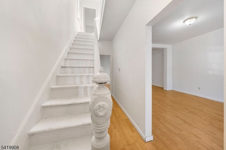 Welcome to this charming and affordable home in Elizabeth, offering a great opportunity for buyers looking for space, value, and potential. The ground floor features a spacious living room and dining room combination, creating an open and inviting layout perfect for everyday living and entertaining. The kitchen offers plenty of space and functionality, ready for your personal touch. Upstairs, you?ll find three generously sized bedrooms along with an updated full bathroom, providing comfort and convenience. A full finished attic adds valuable extra living space ideal for a home office, guest area, or additional bedroom. The partially finished basement includes another full bathroom, offering even more flexibility for recreation, storage, or extended living space. With low taxes and an affordable price point, this home is a fantastic option for first-time buyers or anyone looking to get into the market.Conveniently located just one and a half miles from the train station for an easy NYC commute, and close to shopping, dining, and major routes, this property combines space, practicality, and value?making it a great place to call home.