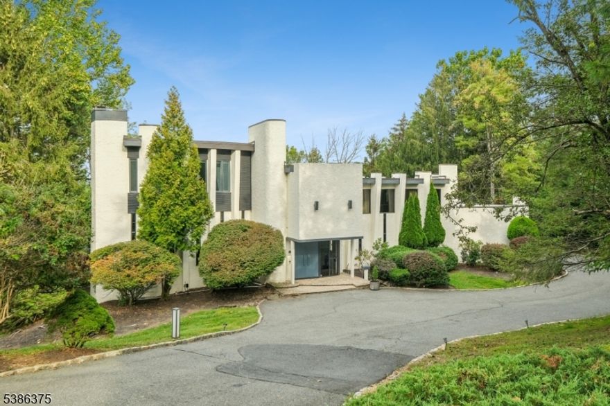 Set on nearly one acre in the prestigious Chestnut Hill section, this contemporary custom residence offers 5 bedrooms and 5.5 baths with an open and versatile layout. Designed for both comfort and entertainment, the floor plan seamlessly connects the main living areas, creating an inviting flow throughout the home. The first level features a private guest suite with full bath, a spacious eat-in kitchen, and a formal dining room that opens to the living room, which extends into the great room. The fully finished walkout basement provides additional living and recreation space, opening directly to a magnificent swimming pool built in 2022, set against a backdrop of lush landscaping and complete privacy your own private retreat. With generous room sizes, abundant natural light, and a premier location, this home stands out as an exceptional opportunity in one of Livingston's most sought-after neighborhoods.