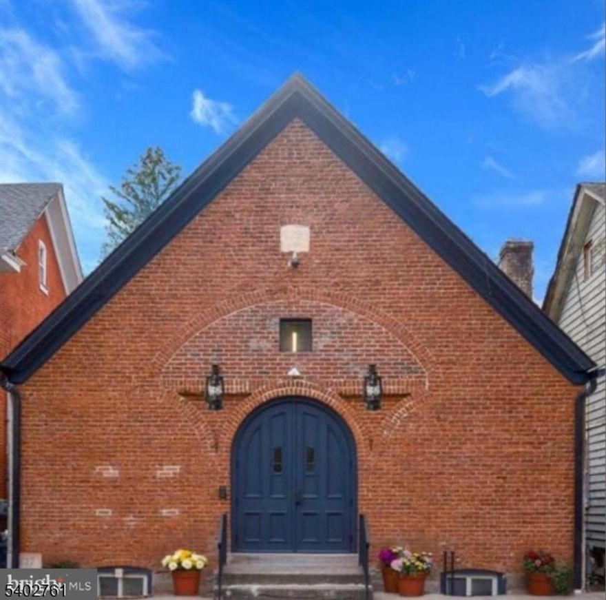 Introducing The Pews at 247 N Main Street an exquisitely restored and re-envisioned antique place of worship offering roughly 3,000 square feet of luminous, open interiors in the heart of Lambertville's art-rich district. Built with remarkable craftsmanship and fully renovated in 2023, this iconic brick landmark seamlessly blends historic character with refined modern design. Currently operating as an elegant office and studio, The Pews is zoned Residential (R-2) and fully permitted for single-family conversion an extraordinary opportunity to create a one-of-a-kind residence. Original arched windows, soaring ceilings, and curated finishes form an inspiring, light-filled sanctuary. The flexible layout and infrastructure allow for endless possibilities spacious primary home, live-work setting, or creative retreat. Features include updated wood and tile flooring, a dramatic glass-walled rear space ideal for a great room or indoor-outdoor lounge, a modernized kitchenette, and a private backyard. All major systems HVAC, roof, windows, bathrooms, and utilities have been fully updated. Whether preserved as an artistic space or reborn as a bespoke home, this revenue-generating property offers remarkable upside in one of New Jersey's most scenic and culturally vibrant towns, moments from the Delaware River, towpath, New Hope bridge, and Lambertville's lively downtown.