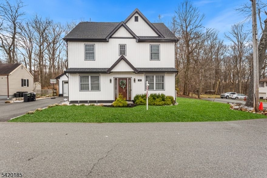 This 2022 gem blends clean architecture, natural light, & a thoughtful layout in one of North Jersey's most sought-after lake communities. The main level unfolds into a bright, open-concept living space defined by wide-plank flooring, oversized windows, & a seamless flow that feels both refined and effortless. The kitchen delivers a polished, high-end aesthetic w/ quartz countertops, SS appliances, custom cabinetry, & a statement island. A first-floor bedroom with a full bath adds a level of flexibility that is increasingly hard to find, ideal for a private office or guest accommodations. Upstairs, the primary suite offers a calm and spacious retreat, complemented by beautifully finished bathrooms featuring modern vanities, glass shower enclosures, & a spa-like soaking tub that elevates daily routines. The third-floor bonus level is an expansive, sun-filled space with lake views that adapts effortlessly as a media lounge, creative studio, or executive workspace. Outside, the fully fenced backyard is complete and ready to enjoy. A finished patio with gazebo creates a private setting for entertaining, quiet evenings, and seasonal gatherings. A detached garage and oversized driveway provide ample parking and everyday convenience. Positioned just minutes from Lake Hopatcong, with easy access to waterfront dining, marinas, and year-round recreation, this location delivers both lifestyle and convenience. Optional lake membership further enhances the experience.