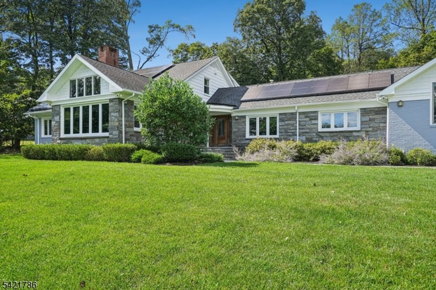 Absolutely stunning, this fully renovated 6-bedroom, 5 full and 2 half bath raised ranch is perched on a hilltop and drenched in natural light, offering tranquility, relaxation, and a seamless connection to nature where everyday living feels like a vacation. The open layout connects expansive living spaces including outdoors, ideal for today's work-from-home lifestyle, This smart home features two solar rooftop systems, all new double-pane windows, and energy-conscious upgrades. The outdoor oasis is unmatched, with a heated in-ground pool, fully equipped pool house with kitchen and full bath, and bluestone patios perfect for dining, lounging, and outdoor movie nights.The formal yet inviting living room showcases dramatic architectural detail, a wall of windows capturing sunrise and NYC skyline sunset views Plans are available for the 3,100 SF basement, where walls, French drains, and five sump pumps are already in place. At the heart of the home is the chef's kitchen and family room, featuring custom Spanish cabinetry, high-end appliances, and a 15' x 6' island with prep sink, wine cooler, and seating for six, plus a separate dining area. A 1st fl laundry rm off the mudroom  3 distinct sleeping/work zones provide flexibility: A 1st fl primary suite w/ fireplace, dressing room, walk-in closet, &  bath, plus a 1st fl bedroom w/bath a 2nd-fl south wing - 3 bedrooms and hall bath; a private north wing studio bedroom with its own staircase,  bath, and sink. A garage w/ EV charger.