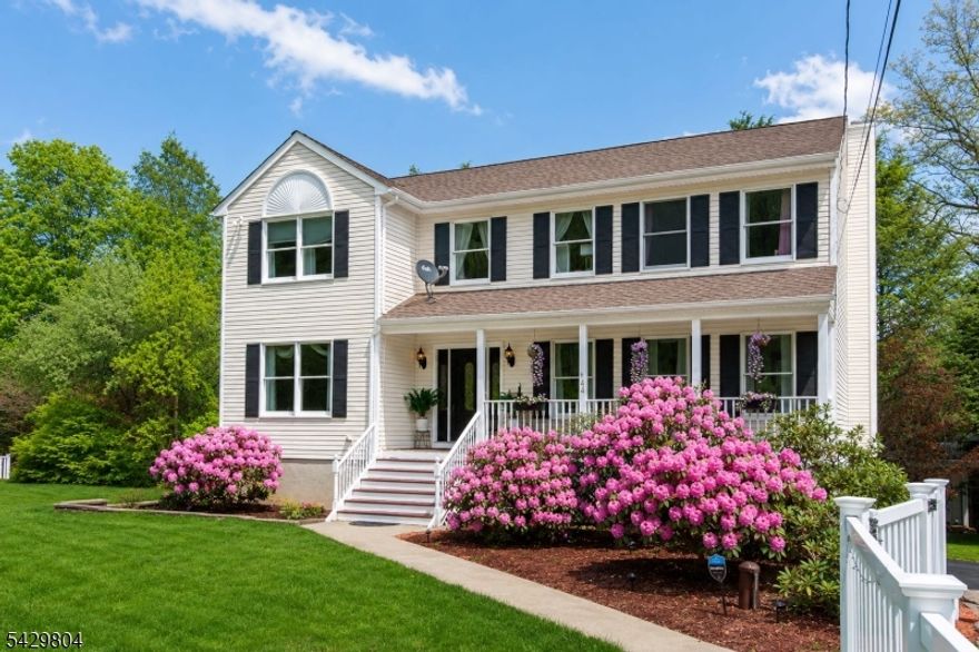 This impeccably maintained 4 bedroom, 2.5 bath center hall colonial blends comfort, style, and functionality, creating a warm and inviting retreat filled with thoughtful details. Gleaming hardwood floors lead you through the formal living and dining rooms to a cozy family room, enhanced by crown molding and custom trim. The heart of the home is the newly updated cherry kitchen, complete with granite countertops, a coffee and wine bar, and two spacious pantries. The open layout flows seamlessly into the family room with a wood burning fireplace, while sliding glass doors lead to two oversized decks, perfect for indoor-outdoor entertaining. A convenient laundry room is located just off the kitchen. A newly fenced backyard with a classic white vinyl picket fence ensures privacy and charm.Upstairs, hardwood floors continue into the serene primary suite, featuring a vaulted ceiling, spa-like en-suite bath, and custom walk-in closet. Three additional bedrooms with custom organizers provide ample storage. The finished walk-out basement offers space for a home office, playroom, or lounge, and the oversized two-car garage adds extra storage. Ideally located near Routes 80, 23, and 287, this home is minutes from the Rockaway Mall, lakes for outdoor activities, hiking trails, and top golf courses. Don?t miss this perfect blend of convenience and comfort! Fireplace/chimney are as is with no known issues