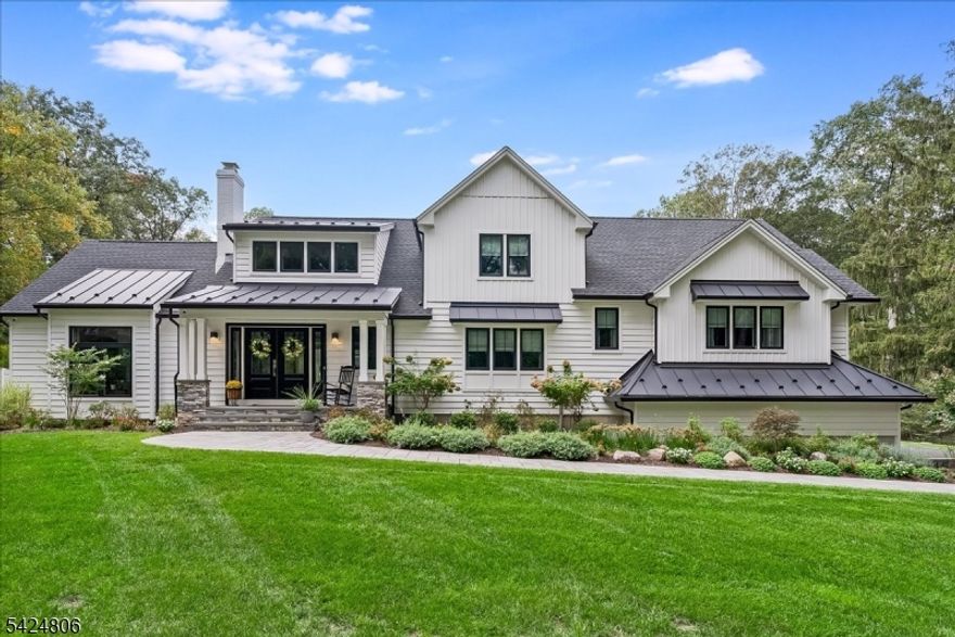 Set on just under 2 acres in one of Denville's most convenient locations, this property offers a rare balance of privacy and proximity- tucked away, yet moments to everything. Thoughtfully renovated + reimagined in 2022, the property is anchored by a custom 4,100sf home, a furnished 1,400sf carriage house and a resort-style outdoor setting. The home features a first-floor primary suite, open concept floorplan where the gourmet kitchen connects seamlessly w/sunken living room, dining/living room spaces, HW flooring, 3 gas fireplaces and 3 car garage. Designed for seamless indoor-outdoor living, the family room features 10-foot center- opening sliders that lead directly to the expansive tiered paver patio. Plenty of entertaining and relaxation space outside whether you're ready to jump in the kidney-shaped heated saltwater pool or unwind by the outdoor WB fireplace w/built in chimney. The carriage house adds another layer of versatility w/ its own 2-car temp-controlled garage, kitchenette, 1.5 baths, W/D, it's ideal as a pool house, private office, or creative studio. Exquisite curb appeal, clean architectural lines, a blend of board and batton with horizontal siding, black framed windows, seam metal roof accents- its dialed in and turnkey for today's luxury buyer. This home is designed for both everyday easy living and elevated entertaining. A setting that feels removed but never disconnected. It delivers space, function and a lifestyle that's rarely available in Denville.