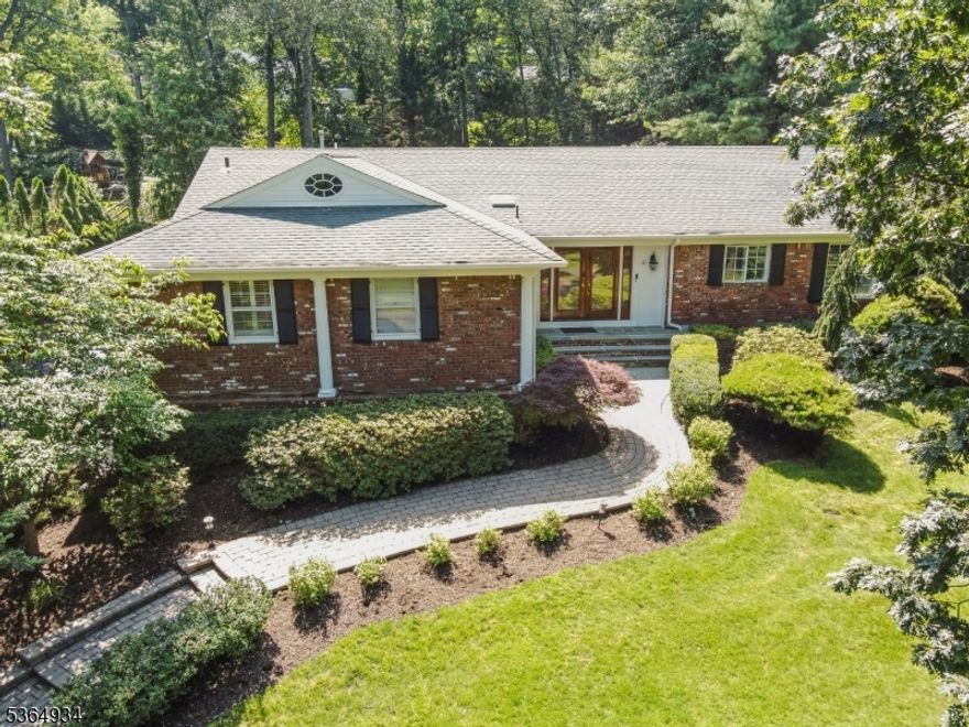 Welcome to your beautiful home in prestigious Short Hills, Deerfield section! Set on an expansive 0.46-acre lot, this residence offers a serene retreat with lush, manicured landscaping, private patios, and a heated in-ground pool perfect for sophisticated entertaining or tranquil relaxation. Inside, you'll find soaring vaulted ceilings, gleaming hardwood floors, and abundant natural light from skylights. The chef's kitchen is a showpiece with a new Thermador cooktop and Bosch dishwasher, seamlessly blending style and function for culinary enthusiasts. The spacious primary suite provides a peaceful sanctuary, while the walkout lower level features versatile office space, a recreation room, a full bath, and direct access to the oversized two-car garage. This home has been thoughtfully updated with a brand-new pool heater and water pump, two new HVAC condensers, two new humidifiers, a new furnace, and a new washer and dryer. Additional features include a central vacuum system, three-zone air conditioning, and an underground sprinkler system. Ideally situated near top-rated Millburn schools, boutique shopping, and NYC transportation, this home offers the perfect blend of refined living and everyday convenience. Discover your fresh start in a home where elegance meets thoughtful updates at every turn