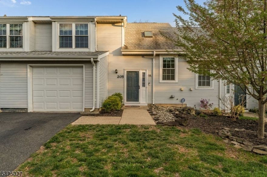 This turnkey 2 bedroom, 2.5 bathroom townhouse offers open concept living with an updated kitchen, updated baths, and move-in ready finishes throughout.The main level flows from the kitchen with ample counter space, a breakfast bar, and generous cabinet storage to the dining area and into the living room, where a wood burning fireplace is featured. A powder room serves the living and entertaining areas on the main floor. Sliding doors open to a large no maintenance composite deck backing to open space and a community playground. The attached one car garage connects directly to the main level, providing interior access and additional storage. Upstairs, both bedrooms feature private en-suite bathrooms along with new wall-to-wall carpeting up the stairs, in the hallway and into the primary bedroom. Quailbrook amenities include a playground, tennis/pickleball courts, and a dedicated walking/jogging path. The location places residents minutes from RWJ Barnabas Health, St. Peter's University Hospital, and Rutgers University, with easy access to Route 287 for commuting throughout Central Jersey and the broader Somerset County area.