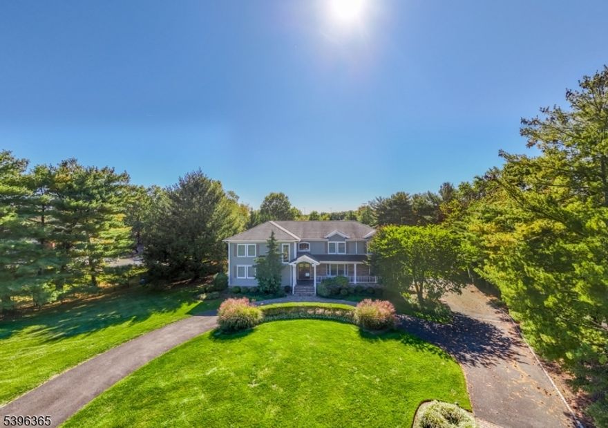 STUNNING 7 BED/7 BATH HOME ON OVER AN ACRE IN PRIME SCOTCH PLAINS LOCATION! This stately home sits on a cul-de-sac w/ a grand circular driveway and wide covered front porch. Step inside to an incredible two-story foyer bathed in light from oversized windows. Dining Room w/ beautiful built-in modern bamboo cabinetry offering storage & service areas including hidden dishwasher! Expansive Family Room w/ two-story ceiling, windows on three sides & stacked stone wood-burning fireplace stretches along the back of the house. In warmer months, opt to dine on the covered flagstone patio just off the Family Room & Kitchen or sit at the bar surrounding the built-in grill. Indoor meal prep is a breeze w/ open Kitchen layout, incredible storage in custom wood cabinetry, professional SS appliances & an L-shaped island w/ bar top. Private bedroom wing on this level offers TWO ensuites and a full hall bath! Upstairs find a Primary Suite overlooking the backyard, 2 closets & large updated Bath w/ double-sink vanity, walk-in shower and separate Jacuzzi tub. Ensuite Bedroom next door has been converted to a dream Dressing Room w/ custom white cabinetry and additional walk-in closet that could easily return to a bedroom if desired. There are 3 other Bedrooms on this level & a spacious Hall Bath. The Lower Level offers even more space to relax with newly finished Rec Room & Full Bathroom. Every detail has been lovingly updated and you couldn't ask for a better place to start your next chapter!
