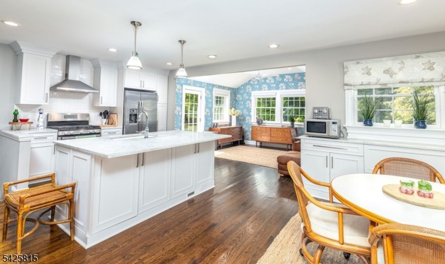 Set on over 4 acres in prestigious Harding, beautifully updated 3-bedroom, 2.5-bath home offering the perfect blend of tranquility & convenience-just minutes from shopping & NYC train. Escape the hustle & bustle & retreat to your own peaceful oasis surrounded by mature landscaping & scenic property views. Inside, the home features a spacious & thoughtfully designed layout, highlighted by an open floor plan. The first floor features a newly redesigned kitchen w/ a center island & separate bar area, perfect for hosting or everyday living. A bright & sunny dining room provides an inviting space for gatherings, while the large living room impresses with its soaring cathedral ceiling & cozy wood-burning fireplace. Upstairs, a huge primary suite features a spa-like bath & sizable walk in-closet. Two additional bedrooms on the 2nd floor share an updated full bath, offering comfort and style. The lower level boasts an oversized family room, ideal for relaxing or entertaining, w/ direct access to a newer screened-in porch featuring a stunning cathedral wainscot ceiling - perfect for enjoying the serene surroundings in any season. A conveniently located half bath & laundry area add to the home's functionality. The oversized garage offers exceptional versatility, with built-in storage & a dedicated work area ideal for hobbies or additional organization. Adjacent is a separate utility space w/ outdoor access, presenting an excellent opportunity to be repurposed as a convenient mudroom.